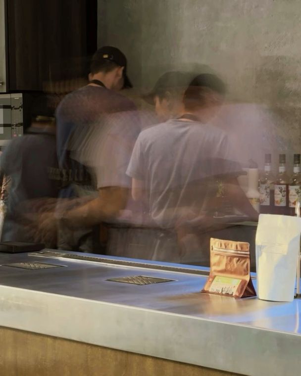 Baristas at work behind a café counter